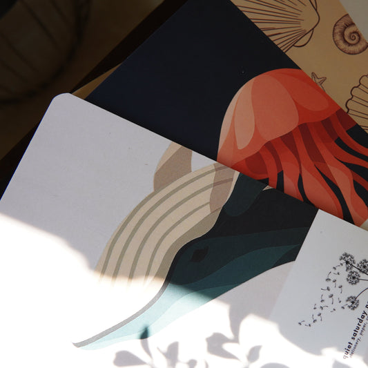 Set of notebooks with artistic designs on a textured surface